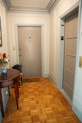a view of a room with a table and wooden floor