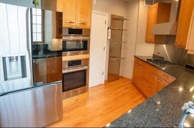 a kitchen with stainless steel appliances a refrigerator and a stove