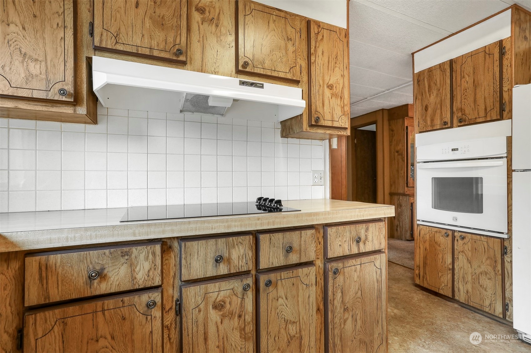 828 Wandering Creek Drive Bothell, WA 98021 - Photo 15 of 40 a kitchen with stainless steel appliances granite countertop a sink a stove cabinets and wooden floor