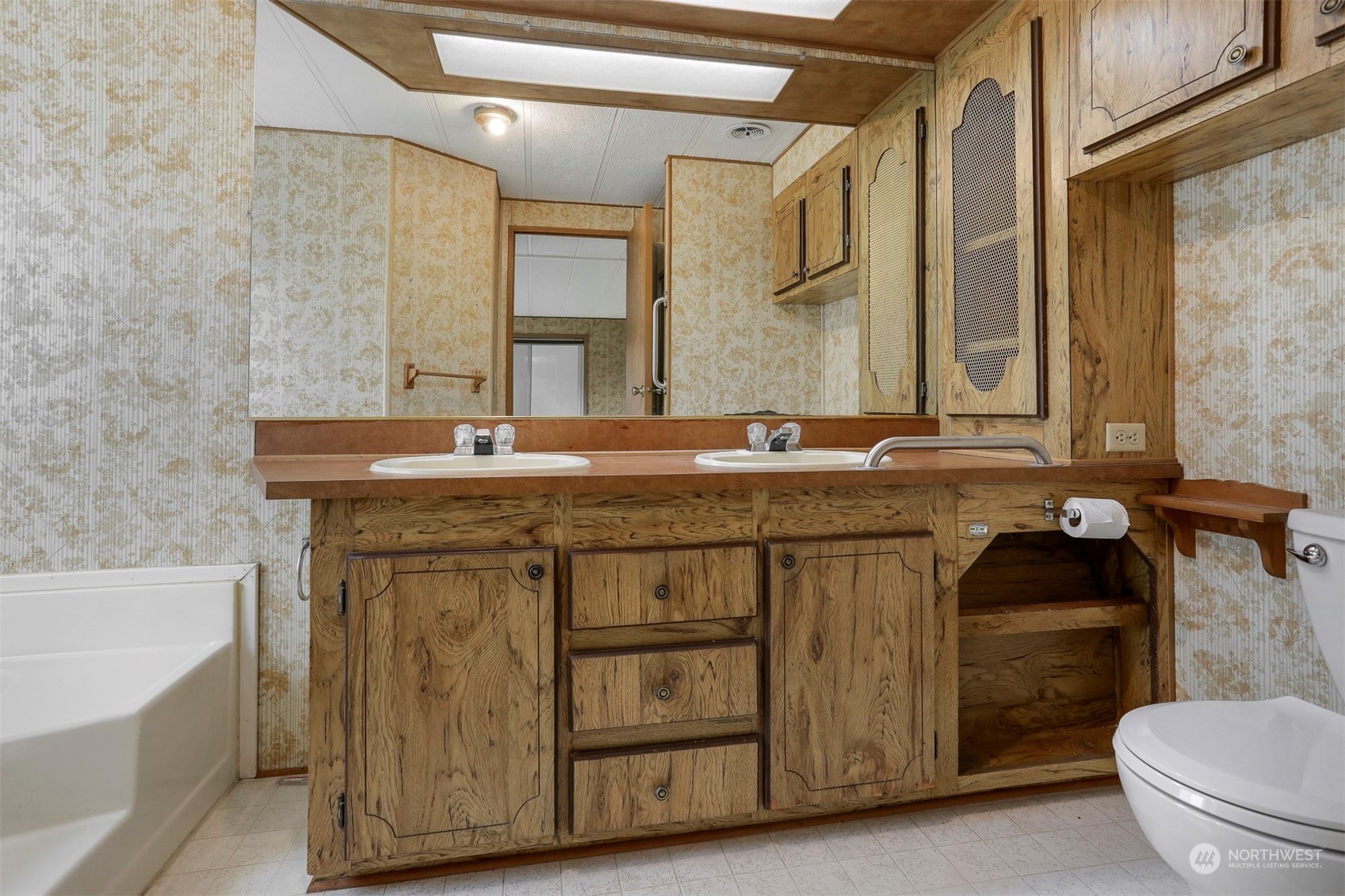 828 Wandering Creek Drive Bothell, WA 98021 - Photo 18 of 40 a bathroom with a granite countertop sink a toilet and a bathtub