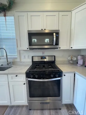 a stove top oven sitting inside of a kitchen