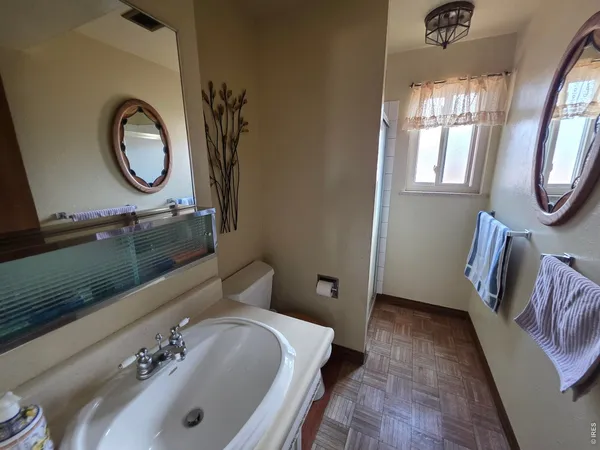 a bathroom with a tub sink and mirror
