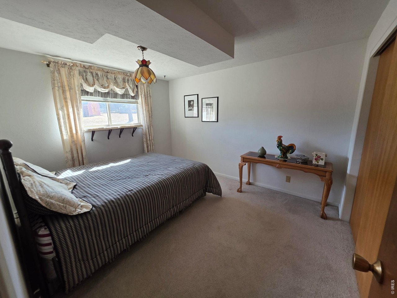 8840 Niwot Road Niwot, CO 80503 - Photo 14 of 34 a bedroom with a bed and window