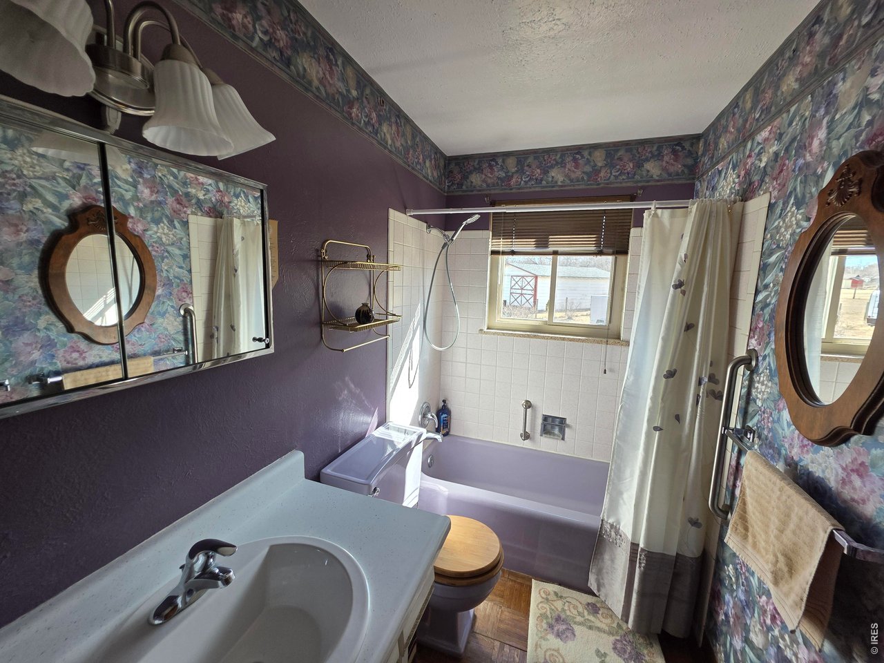 8840 Niwot Road Niwot, CO 80503 - Photo 16 of 34 a bathroom with a granite countertop sink and a mirror