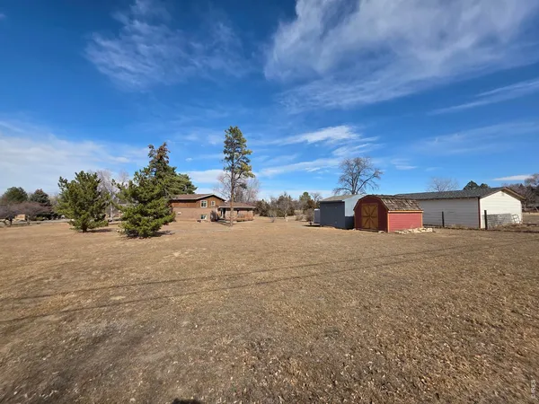 a view of a dry yard with a house