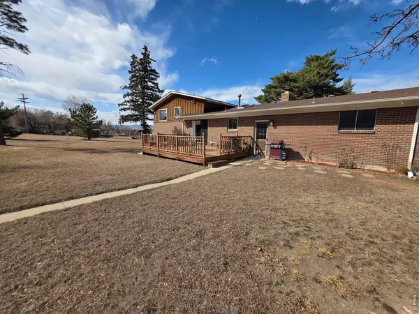 a view of a house with a yard and sitting area