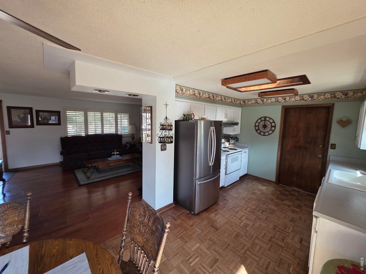 8840 Niwot Road Niwot, CO 80503 - Photo 3 of 34 a living room with furniture and a refrigerator