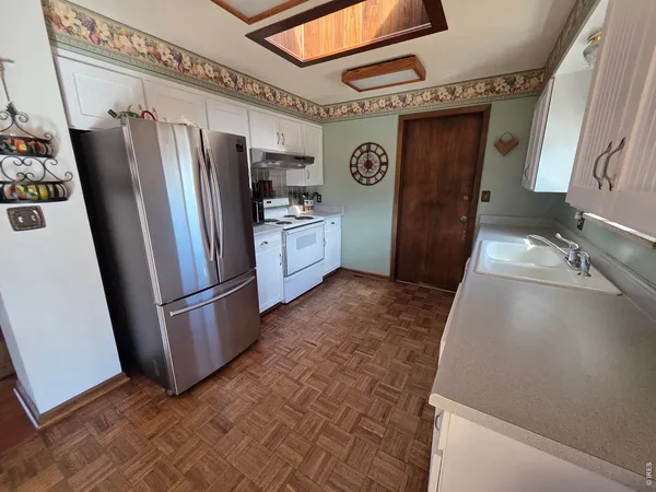 a refrigerator freezer sitting inside of a kitchen