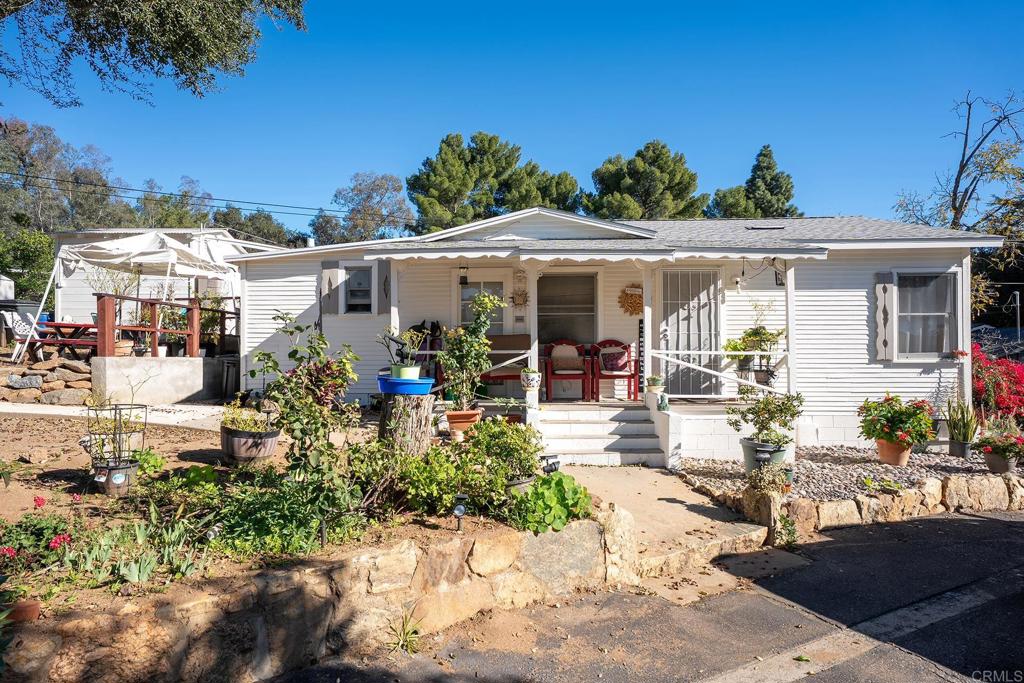 2560-66 Alpine Boulevard Alpine, CA 91901 - Photo 14 of 32 a view of a patio with table and chairs potted plants and palm tree