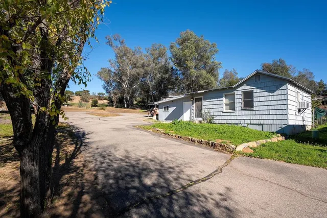 a view of a swimming pool with an outdoor seating and a yard