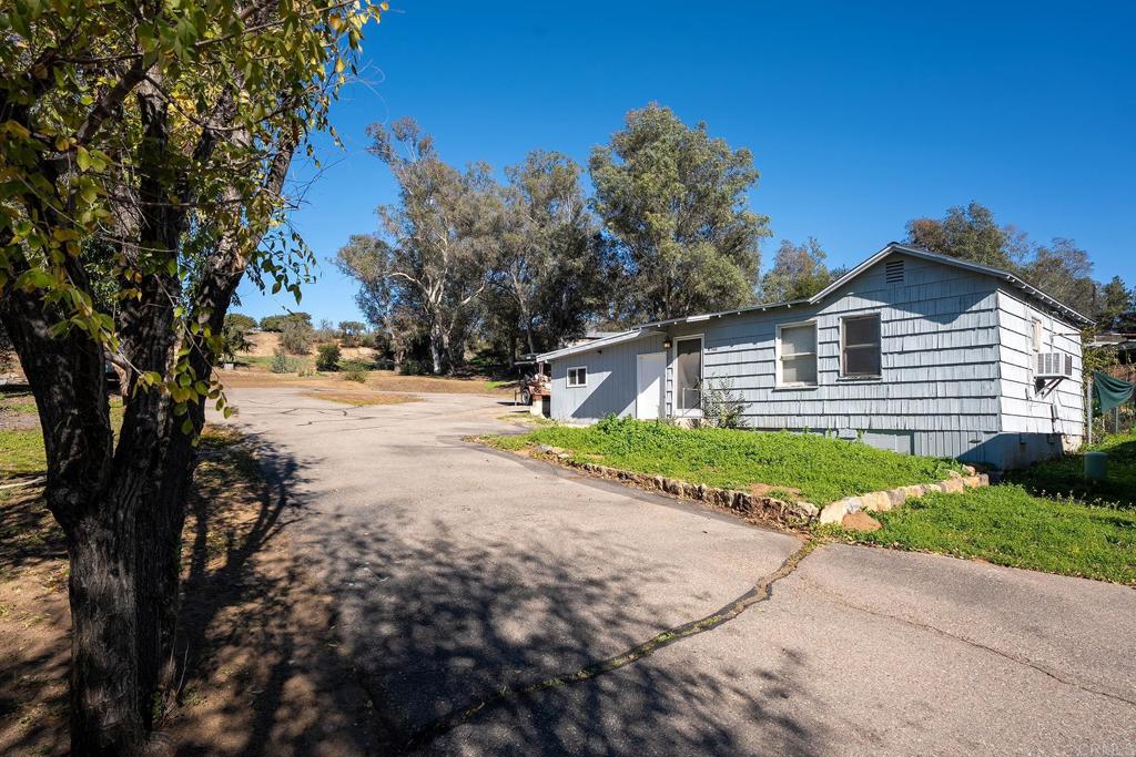 2560-66 Alpine Boulevard Alpine, CA 91901 - Photo 17 of 32 a front view of a house with a yard and garage