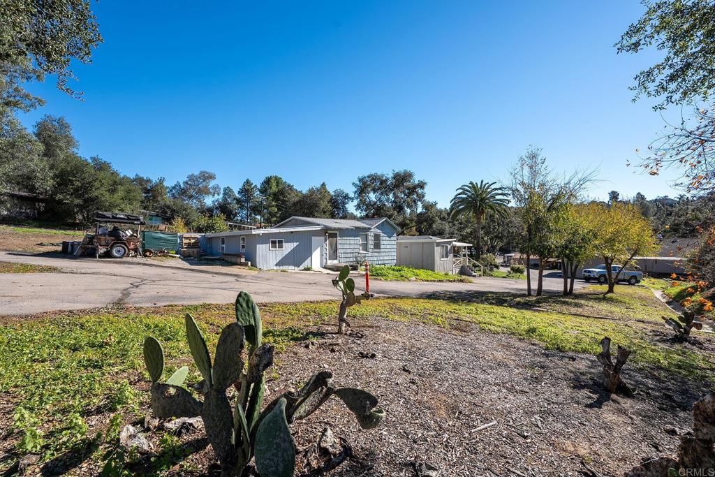 2560-66 Alpine Boulevard Alpine, CA 91901 - Photo 18 of 32 a view of a swimming pool with an outdoor seating and a yard