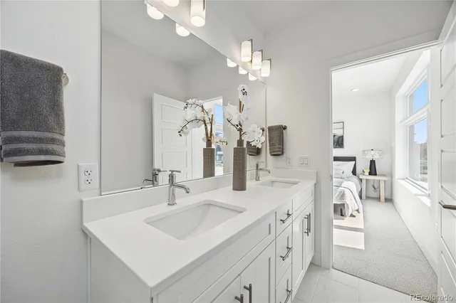 a spacious bathroom with a sink double vanity and a mirror