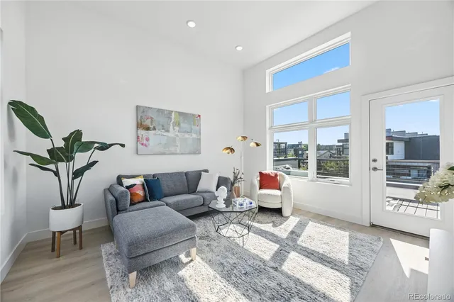 a living room with furniture and large windows