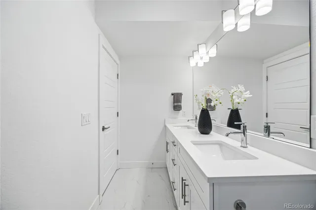 a bathroom with a sink a light fixture and a mirror