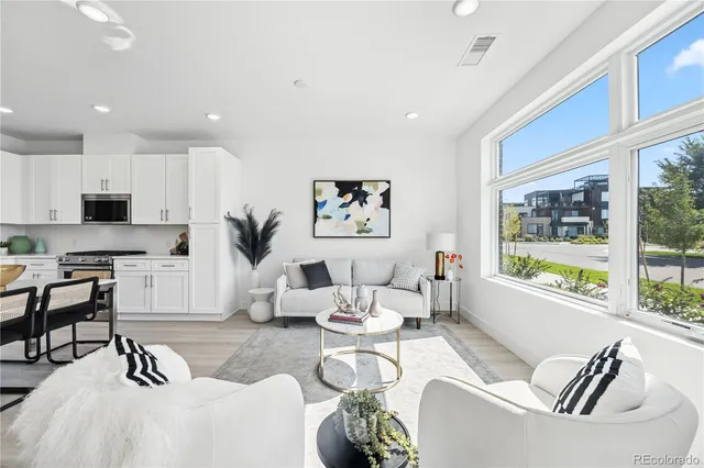 a living room with furniture tv and a large window