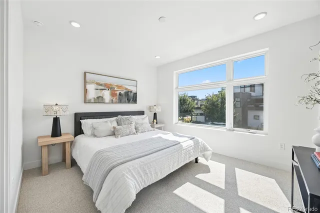 a bedroom with a large bed and a large window