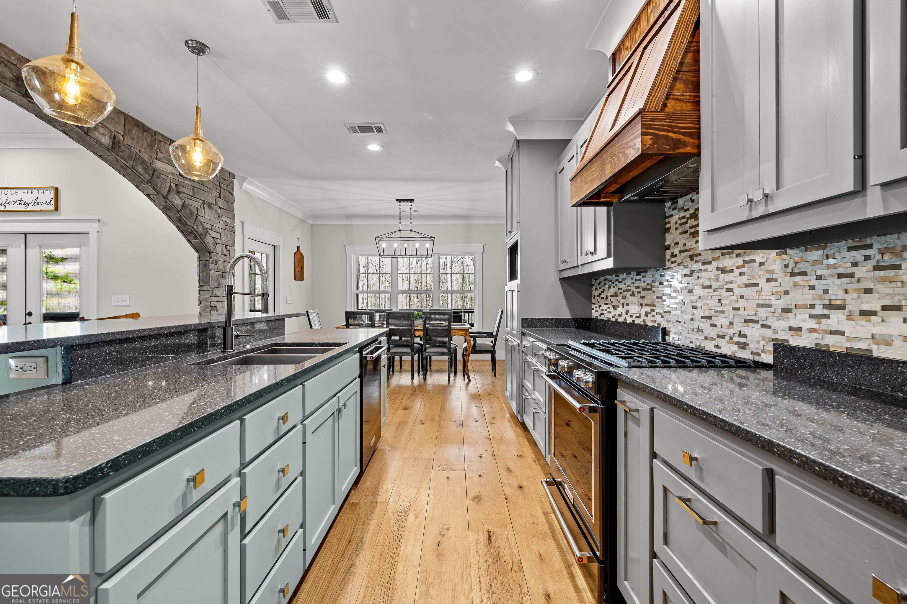 276 Davis Lake Road Thomaston, GA 30286 - Photo 27 of 108 a large kitchen with stainless steel appliances granite countertop a lot of counter space a sink and dishwasher a stove top oven with wooden floor