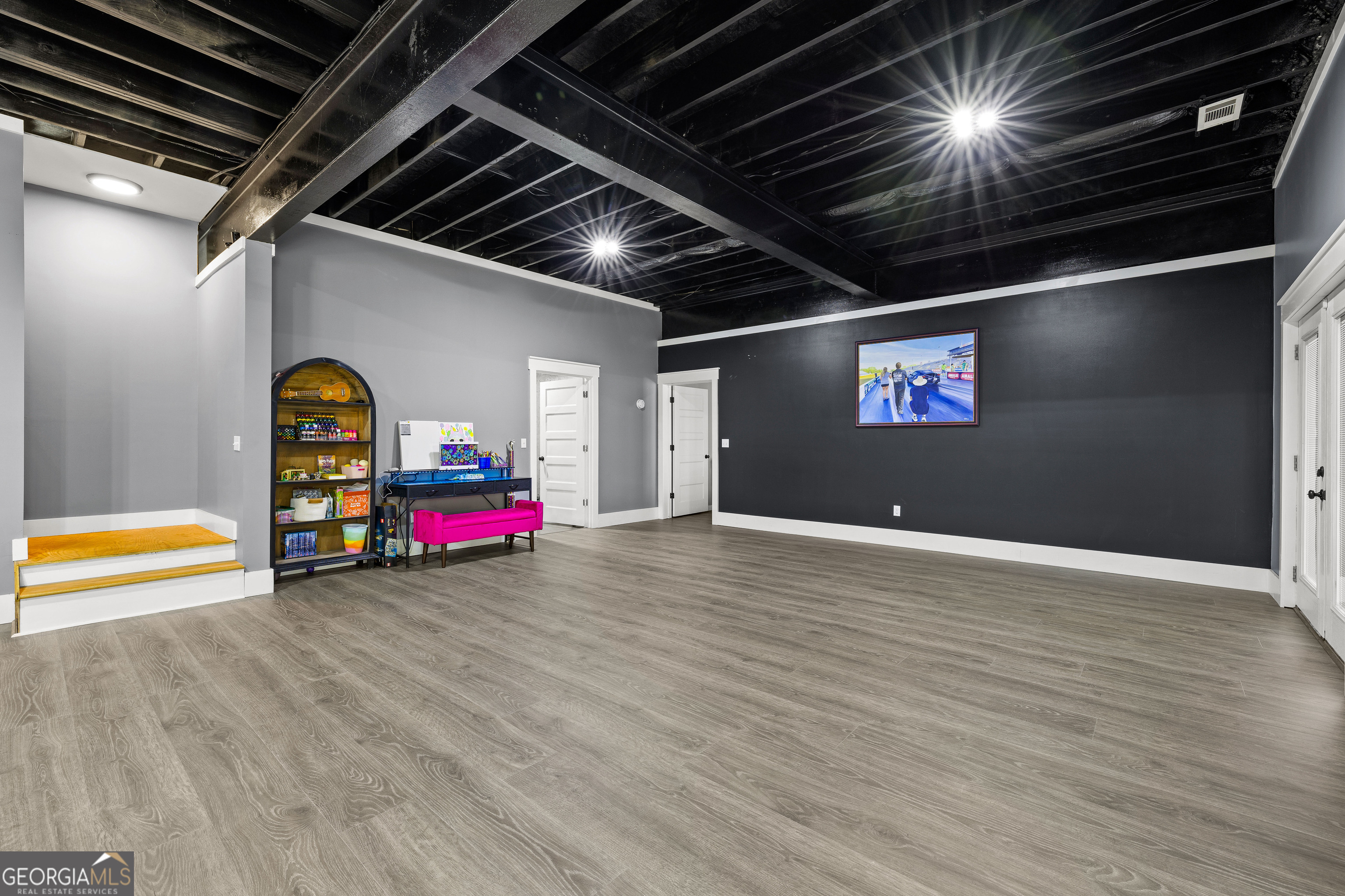276 Davis Lake Road Thomaston, GA 30286 - Photo 77 of 108 a view of an empty room with wooden floor and furniture