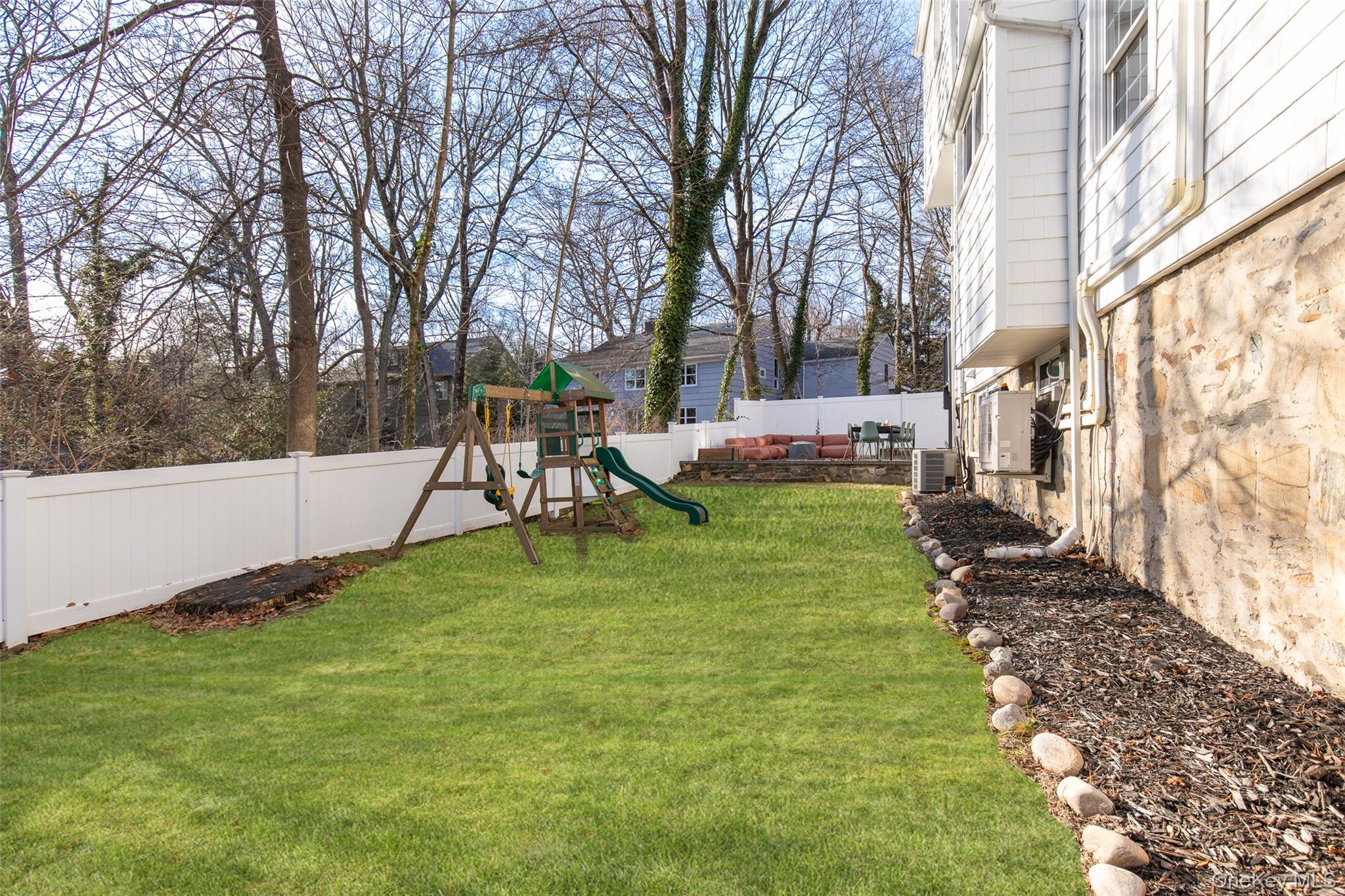 25 Roxbury Road Scarsdale, NY 10583 - Photo 25 of 32 The idyllic and level backyard offers ample room for outdoor living, entertaining, and play.