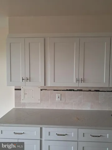 a stove top oven sitting inside of a kitchen