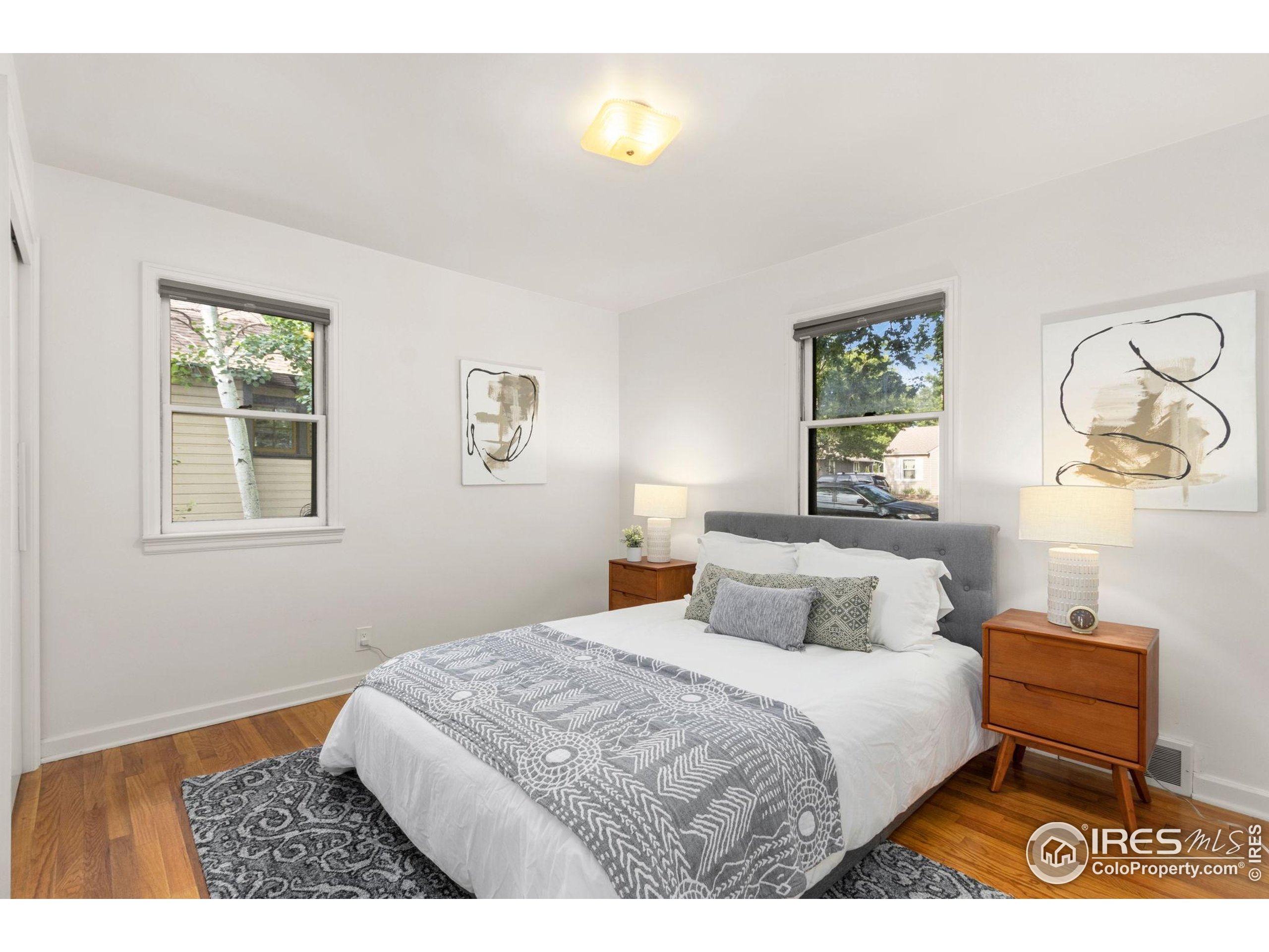 217 Park Street Fort Collins, CO 80521 - Photo 18 of 29 a bedroom with a bed and a painting on the wall