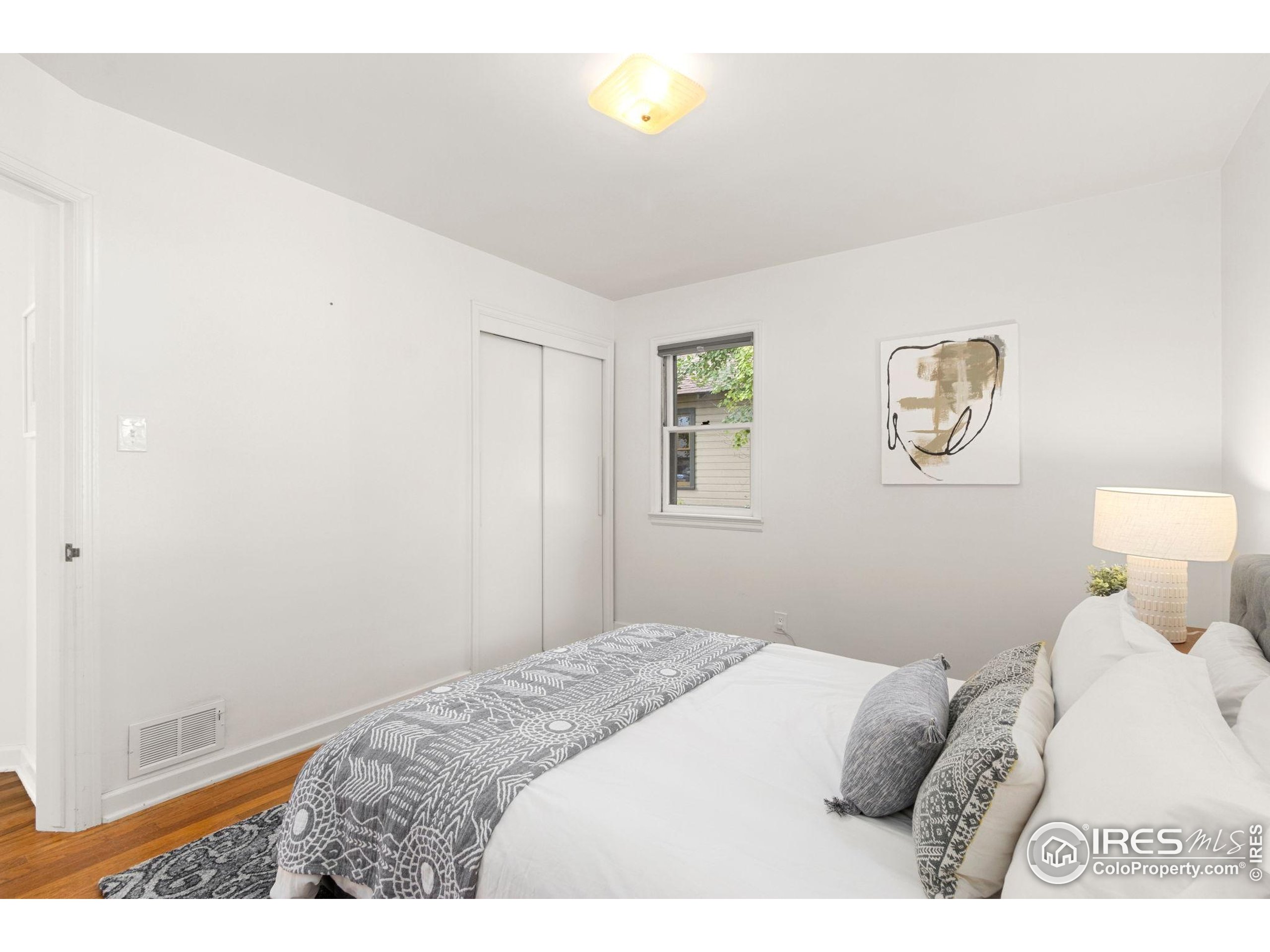 217 Park Street Fort Collins, CO 80521 - Photo 20 of 29 a bedroom with a bed and a lamp