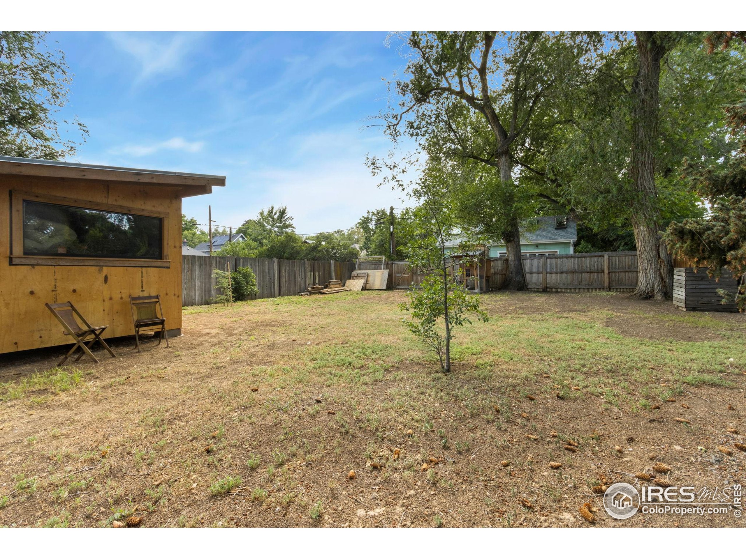 217 Park Street Fort Collins, CO 80521 - Photo 26 of 29 a backyard of a house with barbeque oven table and chairs