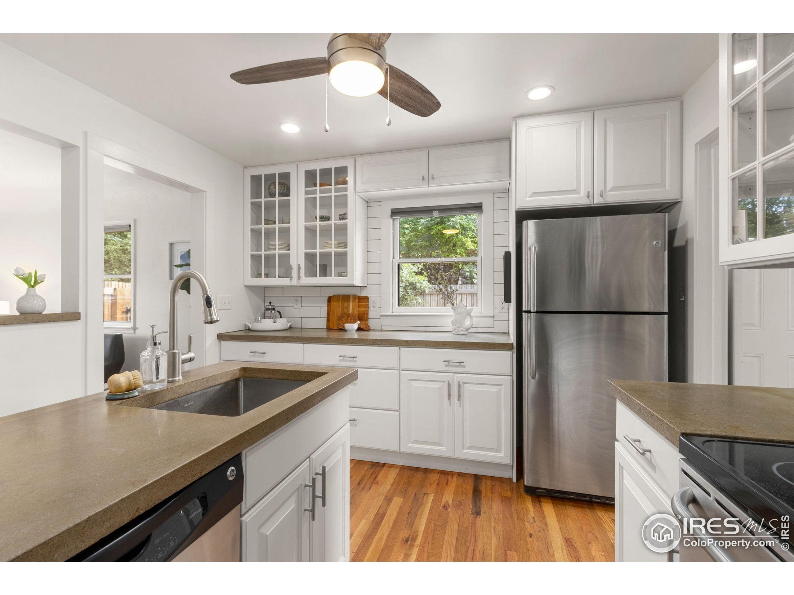 217 Park Street Fort Collins, CO 80521 - Photo 9 of 29 a kitchen with a refrigerator and a sink