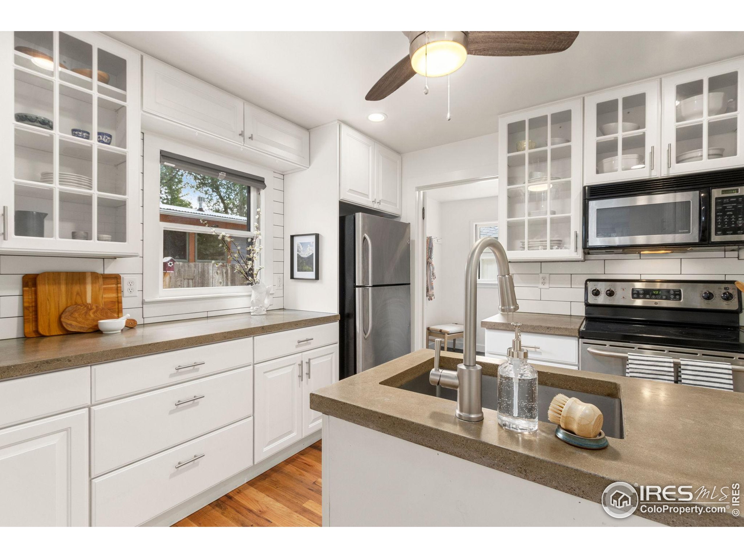 217 Park Street Fort Collins, CO 80521 - Photo 10 of 29 a kitchen with stainless steel appliances granite countertop a sink and a microwave