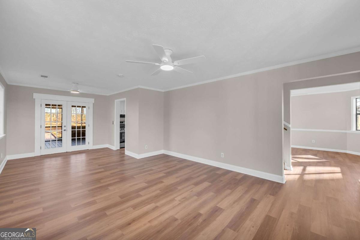 2975 Highway 72 Comer, GA 30629 - Photo 14 of 42 a view of an empty room with window and wooden floor
