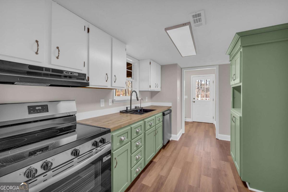 2975 Highway 72 Comer, GA 30629 - Photo 15 of 42 a kitchen with stainless steel appliances granite countertop a stove and a wooden floors