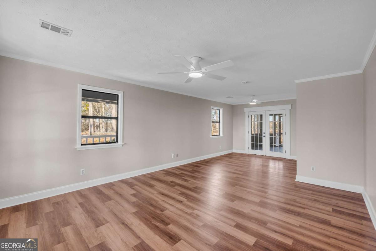 2975 Highway 72 Comer, GA 30629 - Photo 21 of 42 a view of empty room with wooden floor and fan