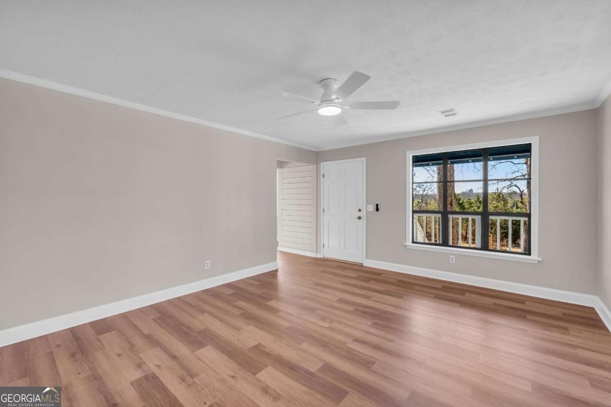 2975 Highway 72 Comer, GA 30629 - Photo 23 of 42 a view of an empty room with a window and wooden floor