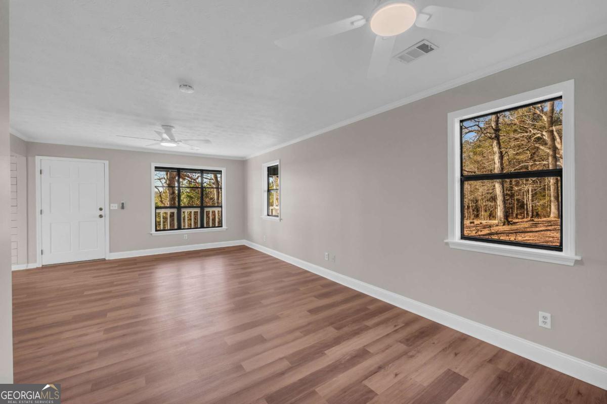 2975 Highway 72 Comer, GA 30629 - Photo 24 of 42 a view of an empty room with wooden floor and a window