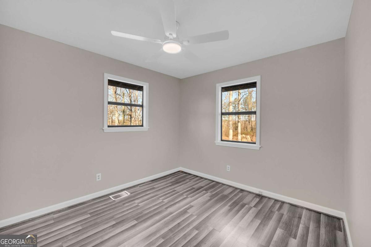 2975 Highway 72 Comer, GA 30629 - Photo 31 of 42 a view of empty room with wooden floor and fan