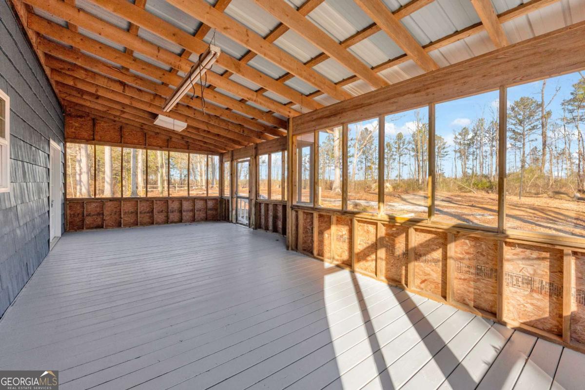 2975 Highway 72 Comer, GA 30629 - Photo 6 of 42 a view of an empty room with wooden floor and a window