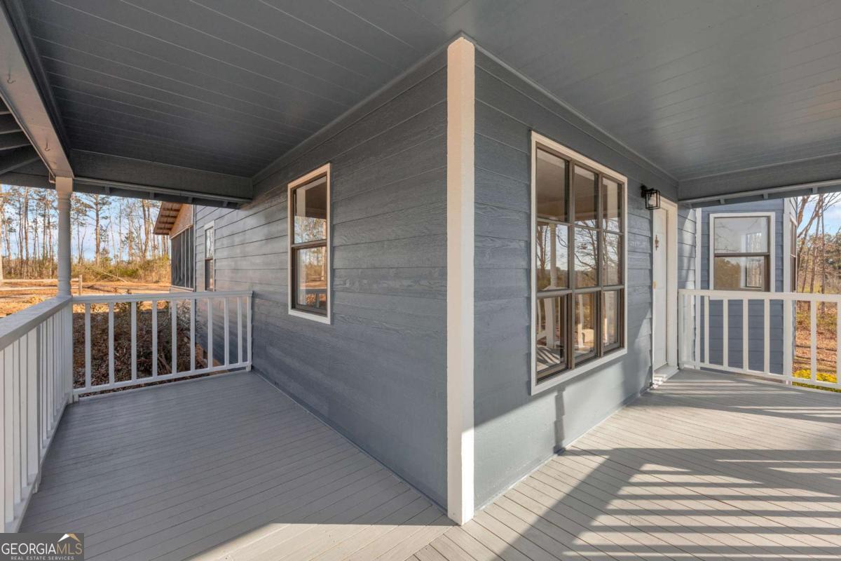 2975 Highway 72 Comer, GA 30629 - Photo 10 of 42 a view of a porch with wooden floor and iron stairs