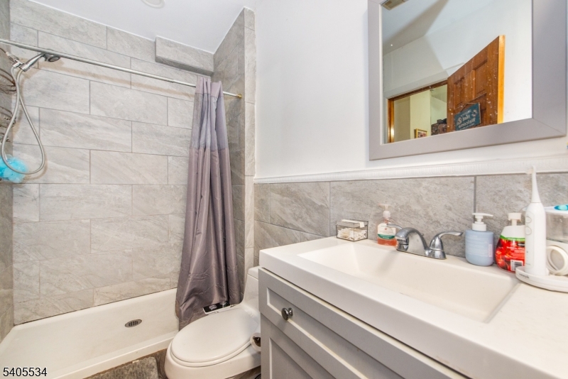 448 East 31st Street Paterson, NJ 07504 - Photo 13 of 23 a bathroom with a sink toilet and shower