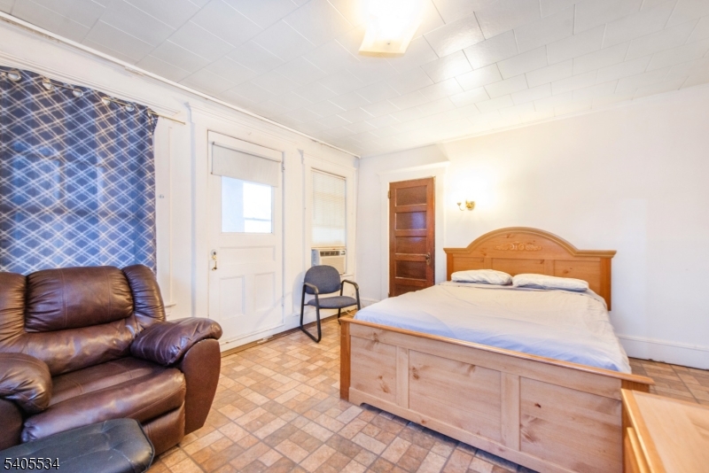 448 East 31st Street Paterson, NJ 07504 - Photo 15 of 23 a bedroom with furniture and a couch