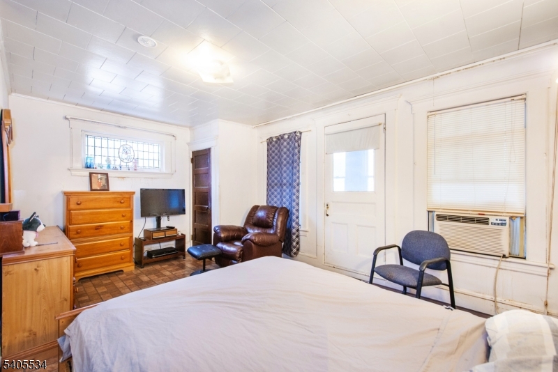 448 East 31st Street Paterson, NJ 07504 - Photo 16 of 23 a bedroom with a bed and wooden floor