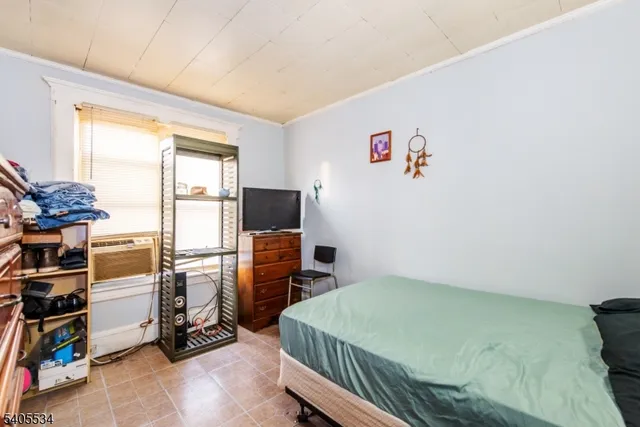 a bedroom with furniture and a window