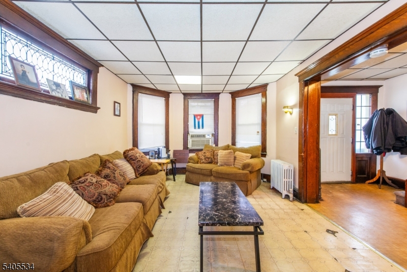 448 East 31st Street Paterson, NJ 07504 - Photo 3 of 23 a living room with furniture and a large window