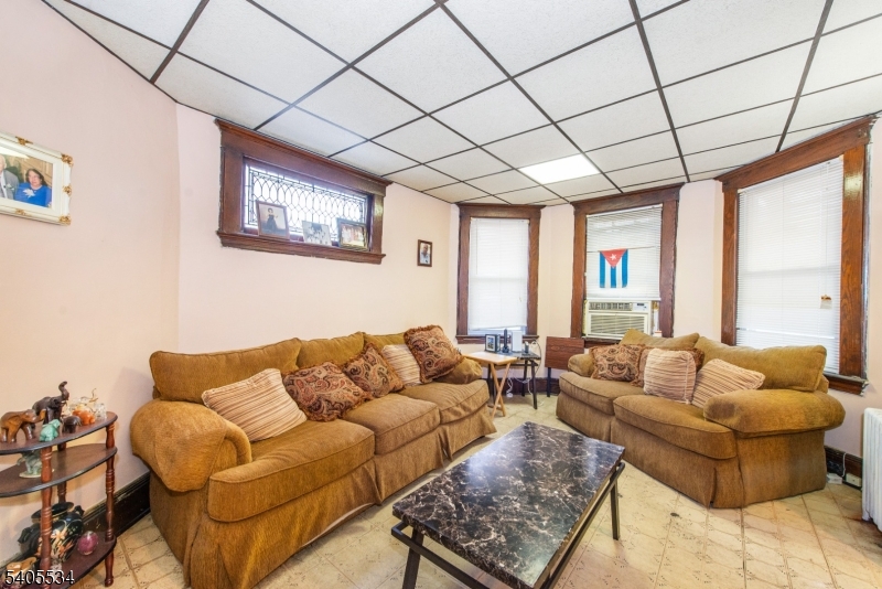 448 East 31st Street Paterson, NJ 07504 - Photo 5 of 23 a living room with furniture and a large window