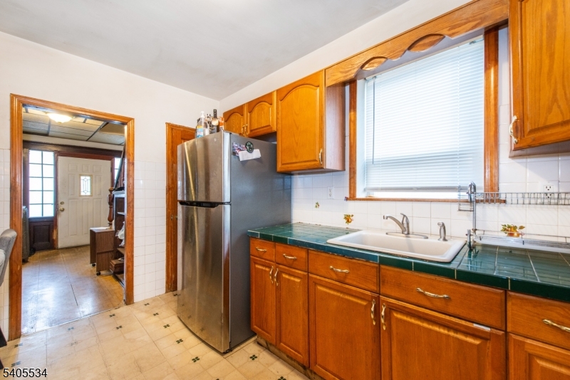 448 East 31st Street Paterson, NJ 07504 - Photo 6 of 23 a kitchen with stainless steel appliances granite countertop a sink and a refrigerator