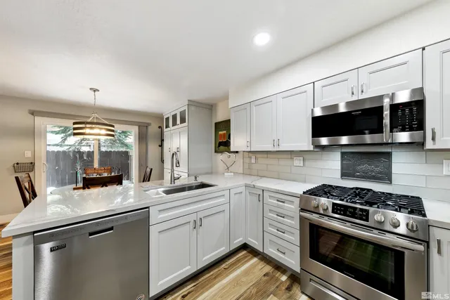 a kitchen with a sink stove and microwave