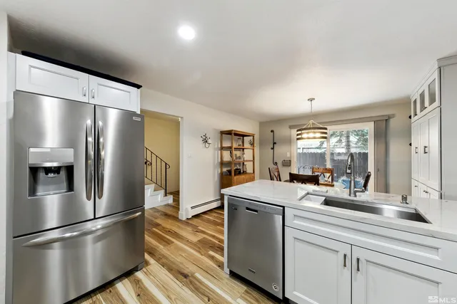 a kitchen with kitchen island a sink appliances and cabinets