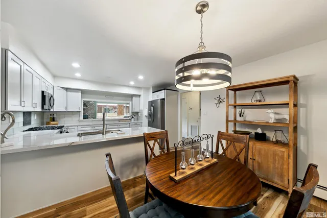 a view of a dining room with furniture wooden floor and chandelier