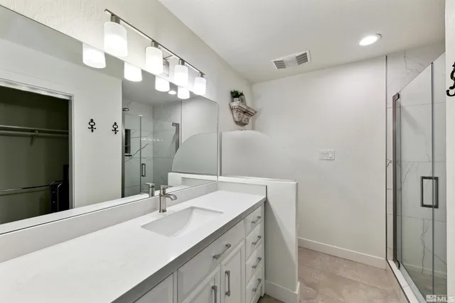 a bathroom with a sink double vanity and a mirror