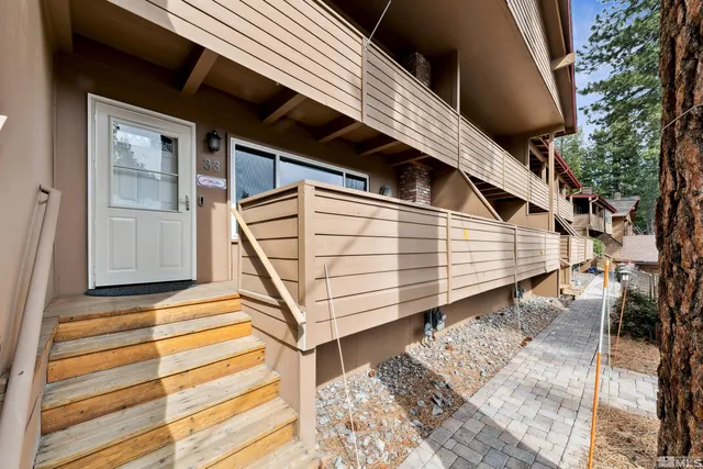 a view of a house with a door and wooden floor